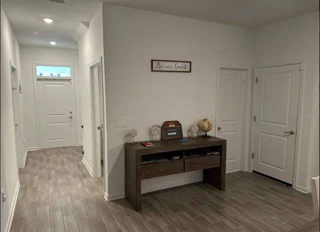 a view of room with wooden floor and closet