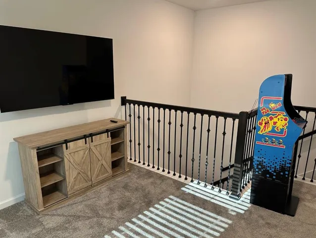 a view of a livingroom with wooden floor and furniture