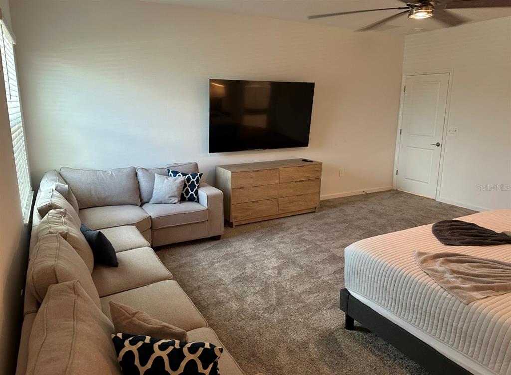 2759 Slash Way St. Cloud, FL 34771 - Photo 22 of 45 a living room with a couch and a flat screen tv