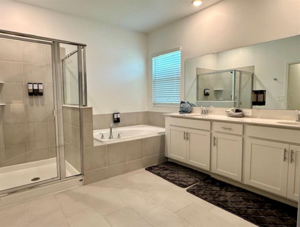 2759 Slash Way St. Cloud, FL 34771 - Photo 23 of 45 a bathroom with a tub sink and mirror