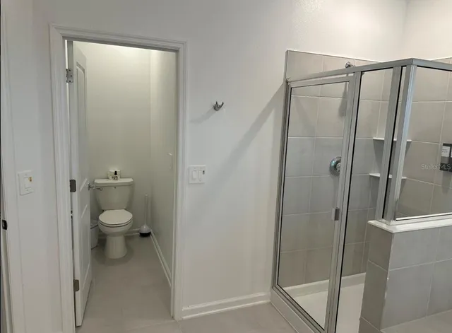 a bathroom that has a toilet shower and a sink