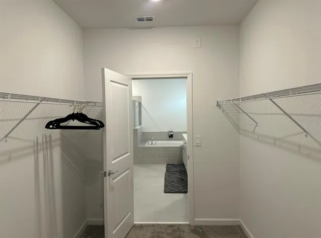 a bathroom with a granite countertop shower and a sink