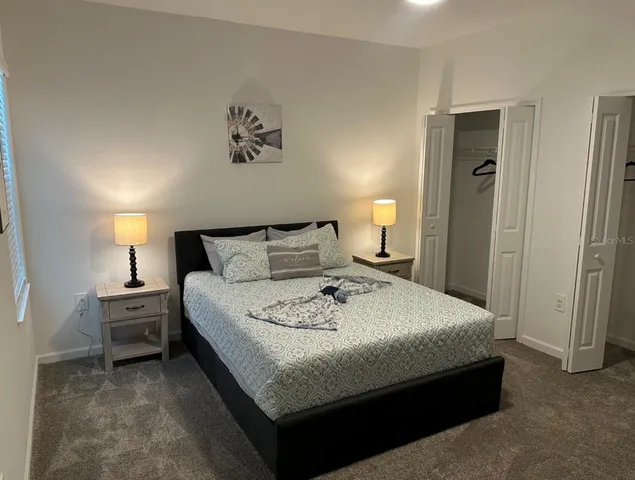 a bedroom with bed and window