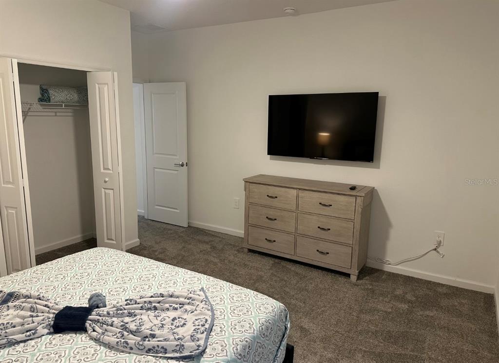 2759 Slash Way St. Cloud, FL 34771 - Photo 32 of 45 a bedroom with a bed and a flat screen tv
