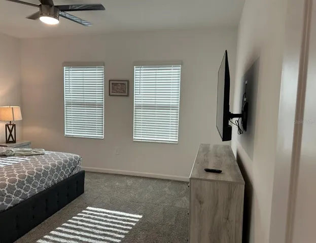 a bedroom with bed and a window