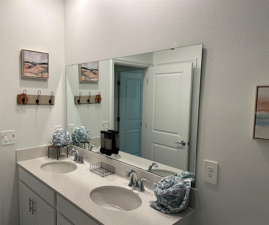 2759 Slash Way St. Cloud, FL 34771 - Photo 36 of 45 a bathroom with a sink and a mirror