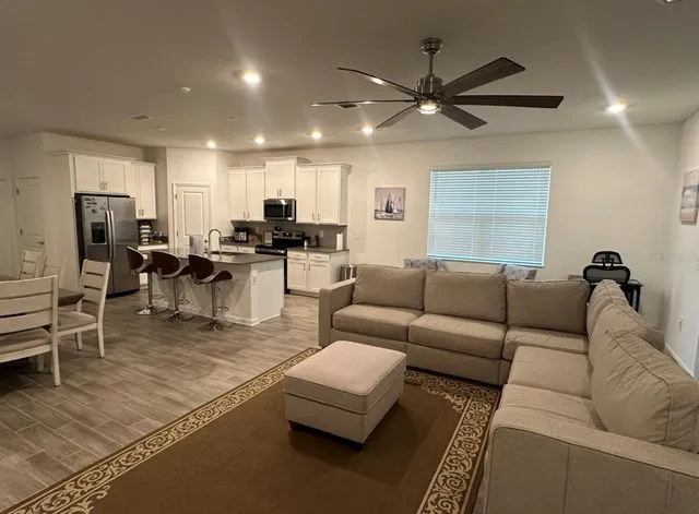 a living room with furniture and a large window