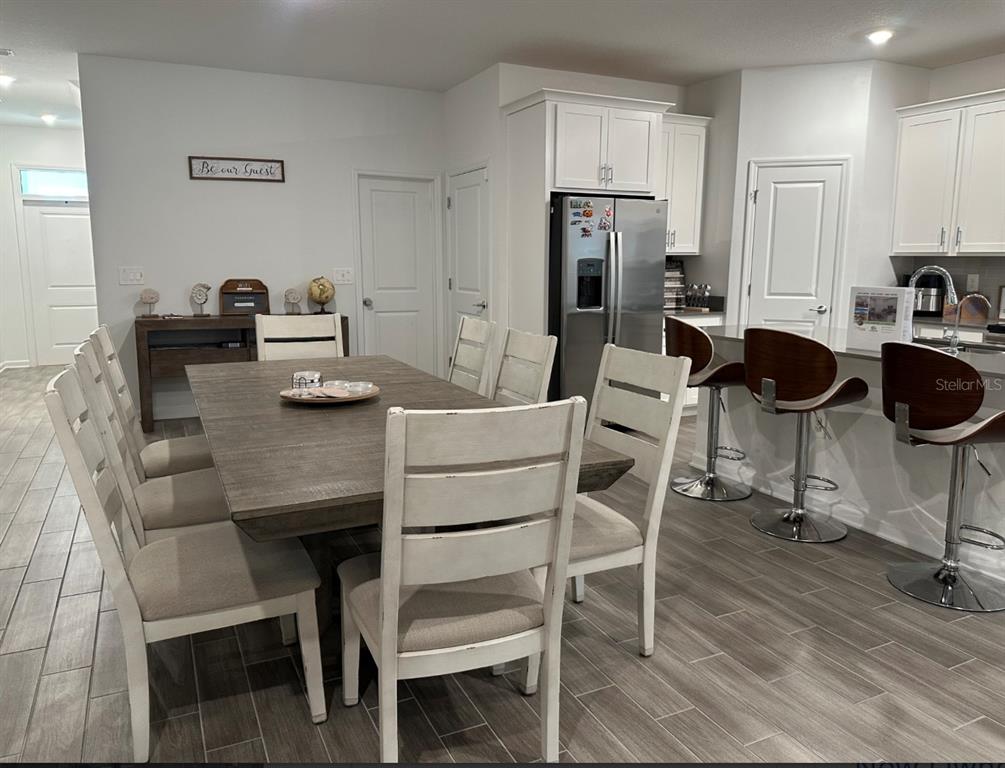 2759 Slash Way St. Cloud, FL 34771 - Photo 10 of 45 a kitchen with a dining table chairs and refrigerator
