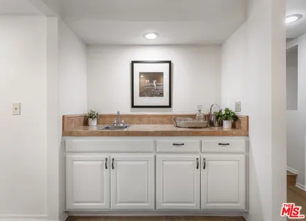 a bathroom with a granite countertop sink a toilet and a mirror