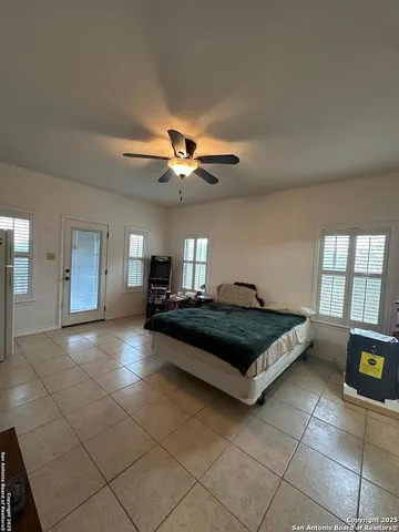 a spacious bedroom with a bed and a chandelier