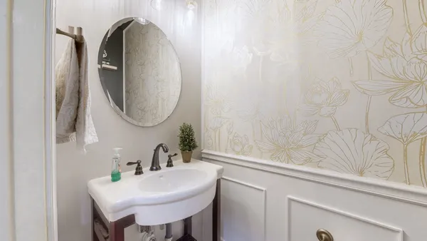 a bathroom with a tub a sink and a window