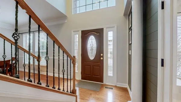 a view of front door with wooden floor