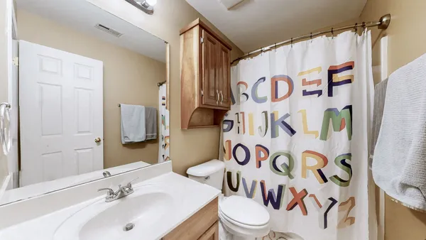 a bathroom with a double vanity sink and a mirror