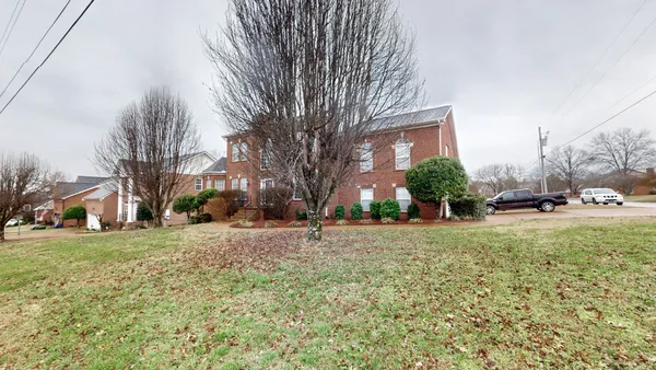 an aerial view of house with yard