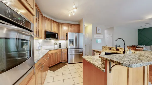 a kitchen with cabinets and refrigerator