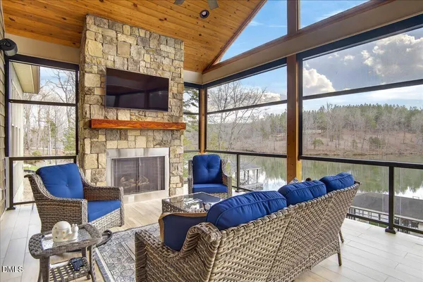 a bathroom with a granite countertop bathtub shower sink mirror and toilet