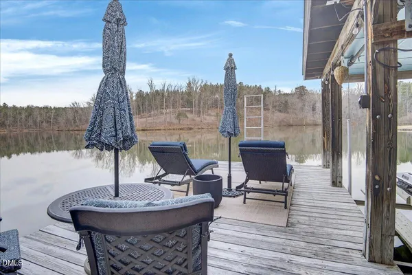 a bathroom with a granite countertop shower sink vanity and mirror