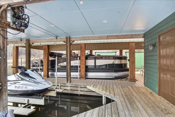 a bathroom with a granite countertop shower sink vanity and toilet