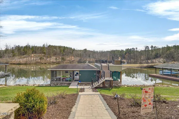a living room with furniture a flat screen tv and a large window
