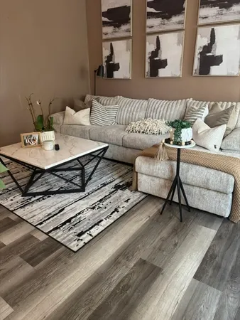 a living room with furniture and wooden floor