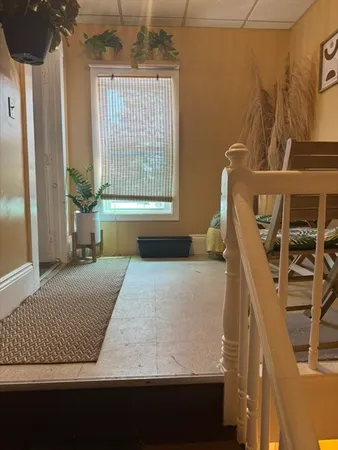 a bed sitting in a bedroom next to a window
