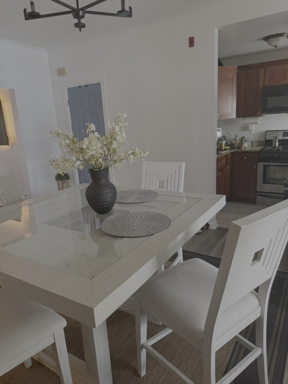 12 Lansdowne Court, Unit 12 Lawrence, MA 01841 - Photo 5 of 5 a kitchen with a table and chairs