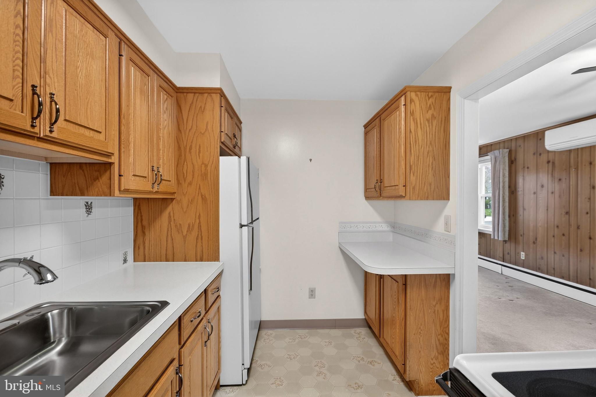 821 Kenyon Lane Newark, DE 19711 - Photo 16 of 50 a kitchen with stainless steel appliances granite countertop a sink a stove and a refrigerator