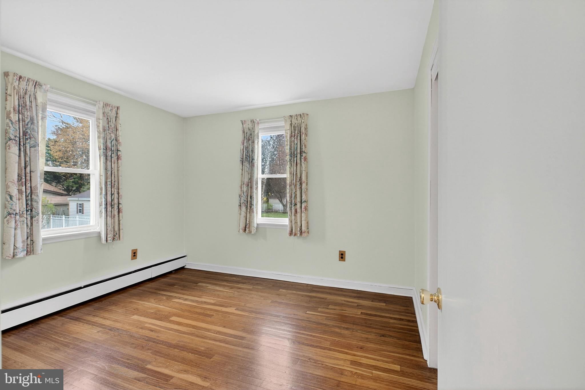 821 Kenyon Lane Newark, DE 19711 - Photo 17 of 50 an empty room with wooden floor and windows