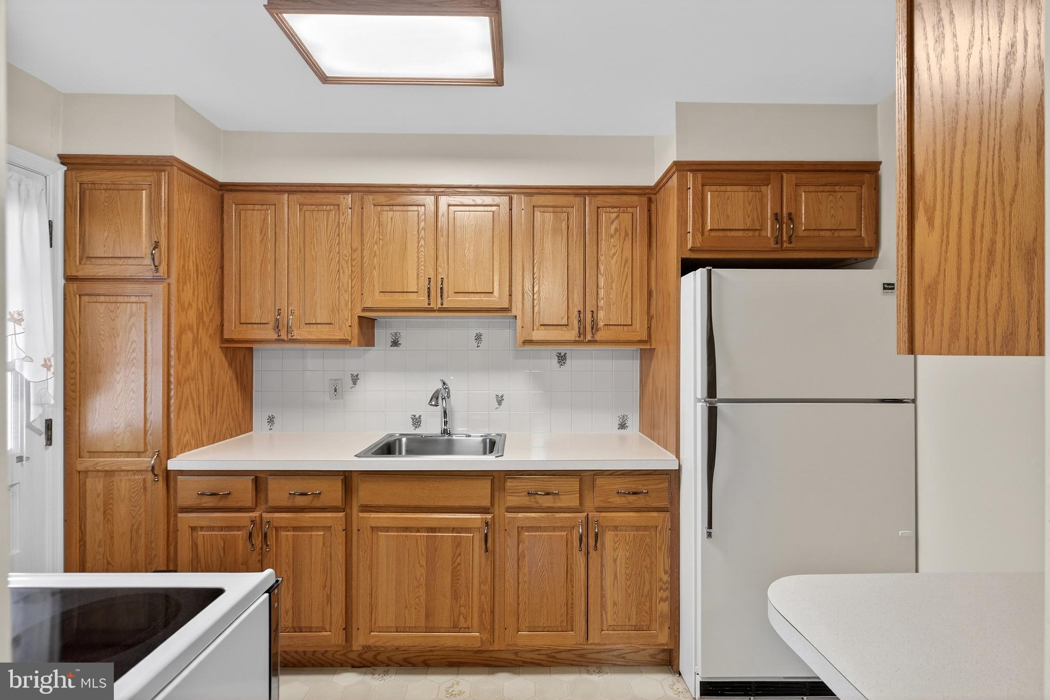 821 Kenyon Lane Newark, DE 19711 - Photo 19 of 50 a kitchen with stainless steel appliances granite countertop a refrigerator sink and cabinets