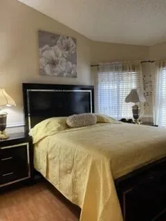 a bedroom with a bed and window