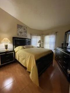 a bedroom with a bed and a chandelier