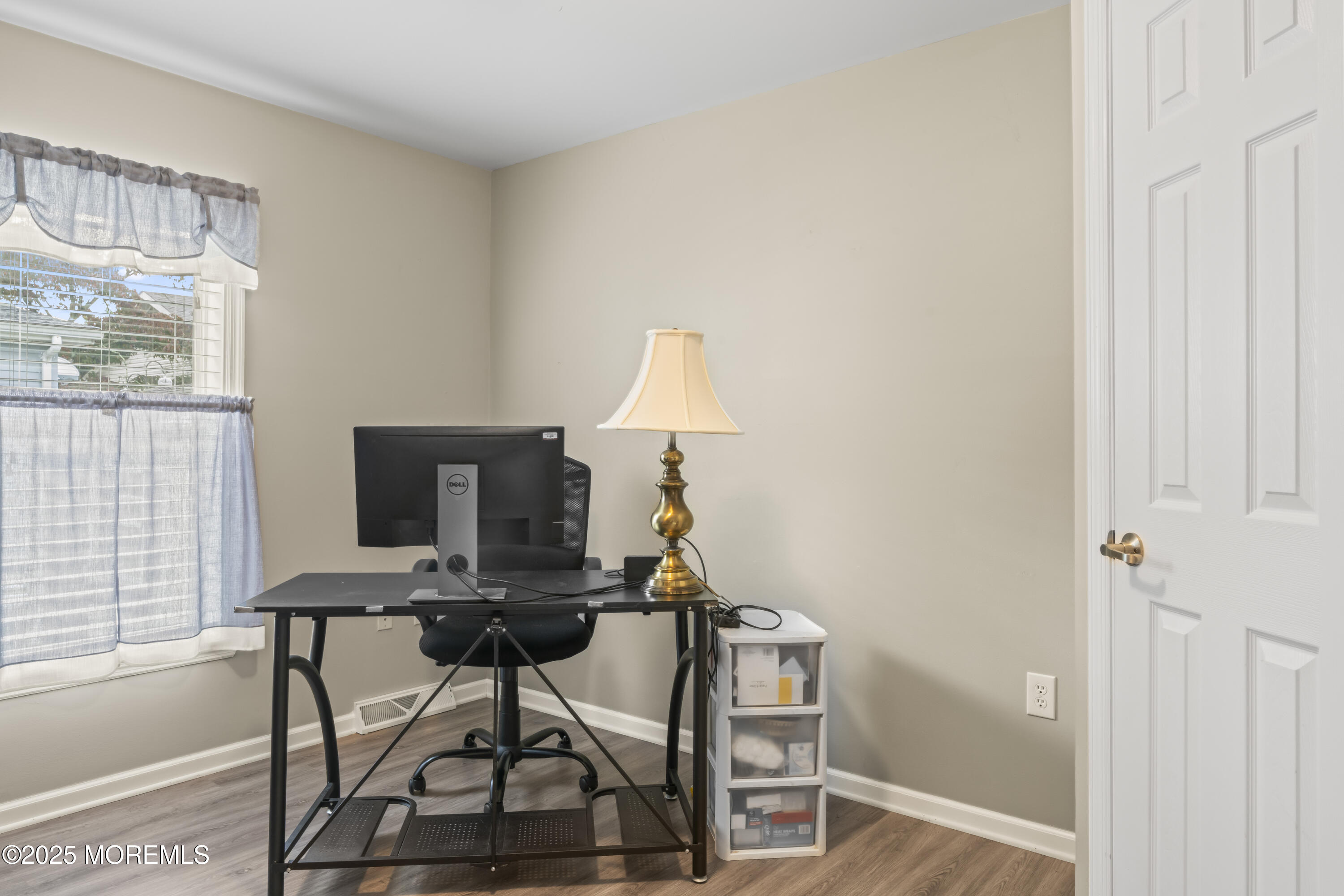 75 Village Road Morganville, NJ 07751 - Photo 16 of 27 a view of a workspace with furniture and a window