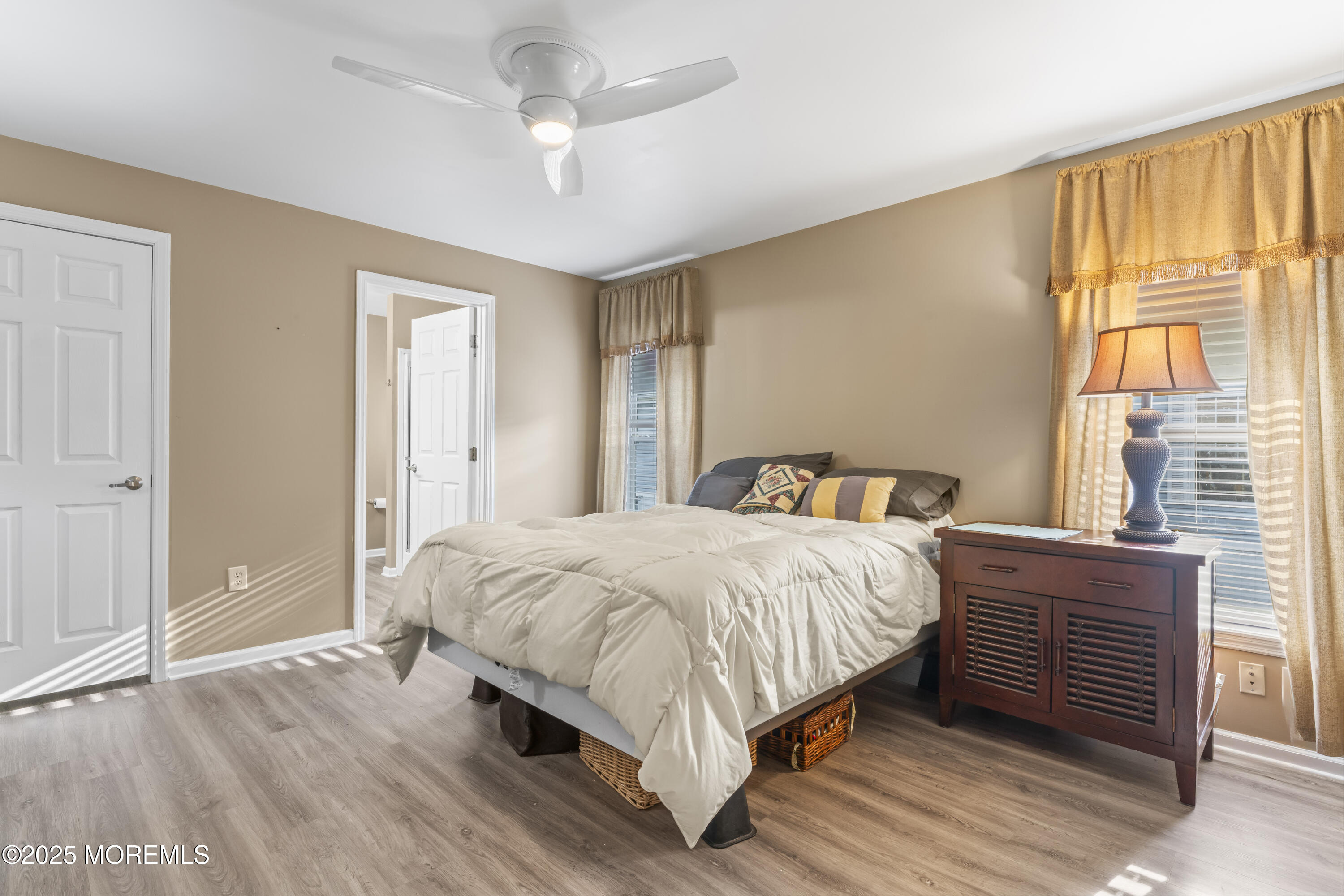 75 Village Road Morganville, NJ 07751 - Photo 19 of 27 a bedroom with a bed wooden floor and window