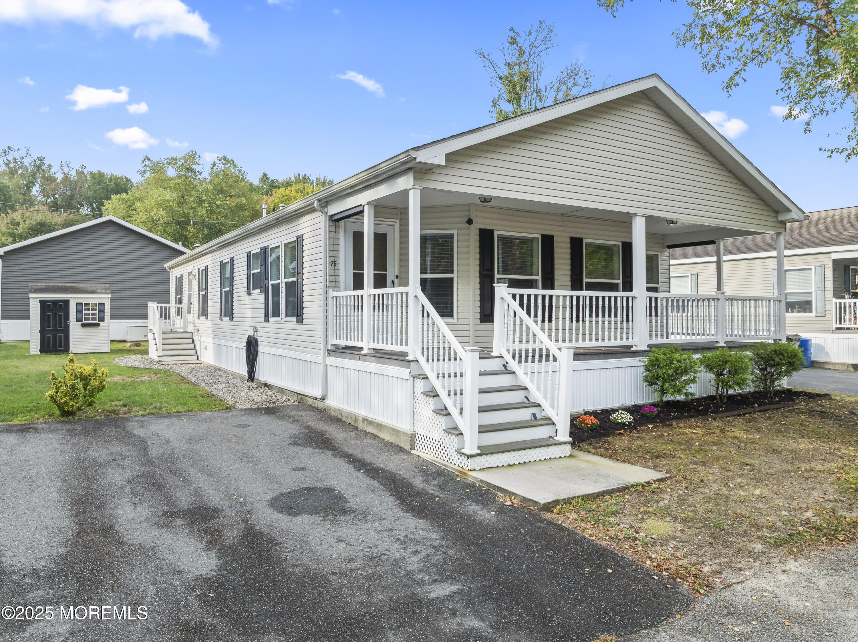 75 Village Road Morganville, NJ 07751 - Photo 2 of 27 front view of a house with a yard