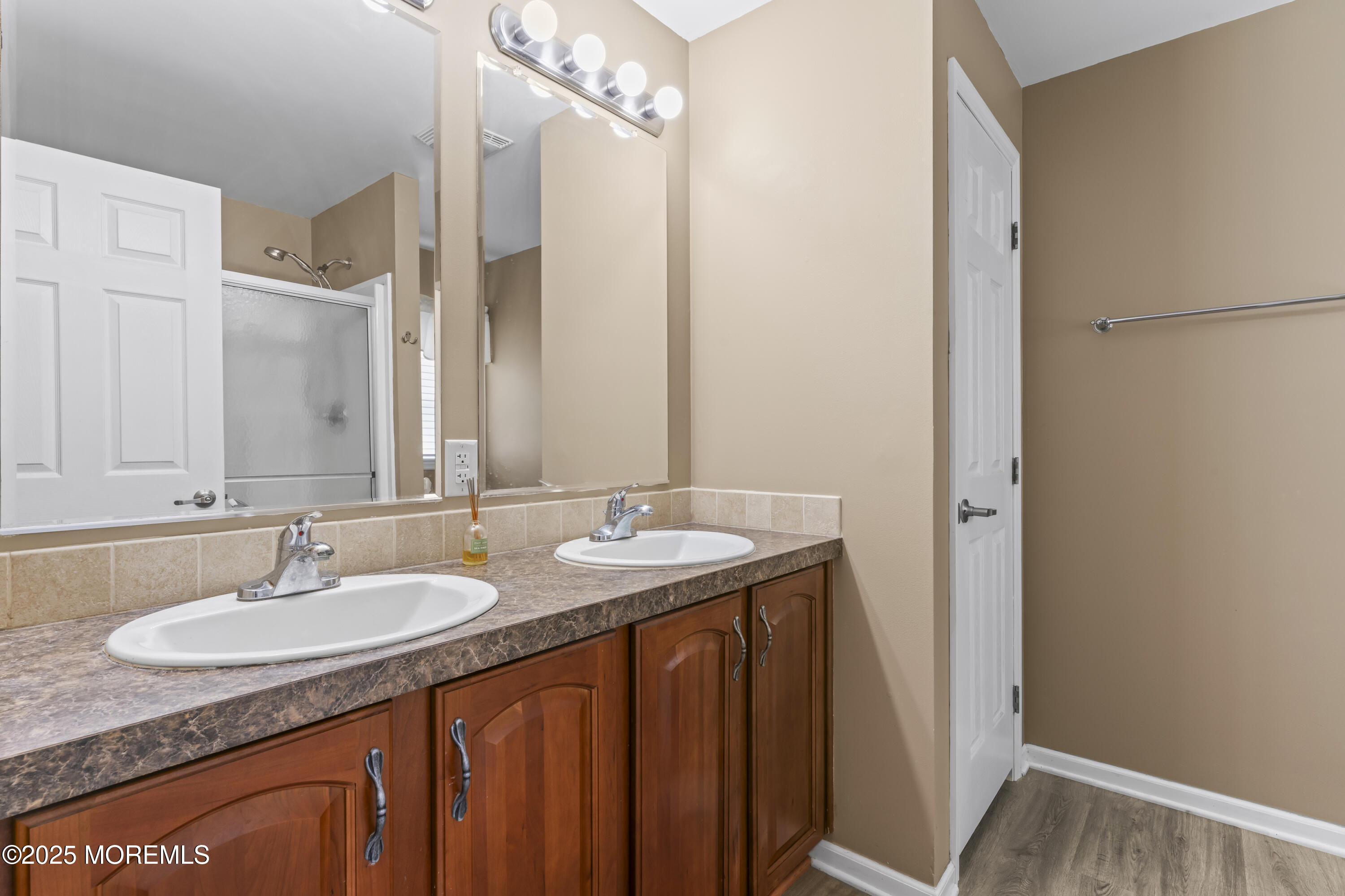 75 Village Road Morganville, NJ 07751 - Photo 21 of 27 a bathroom with a granite countertop sink and a mirror