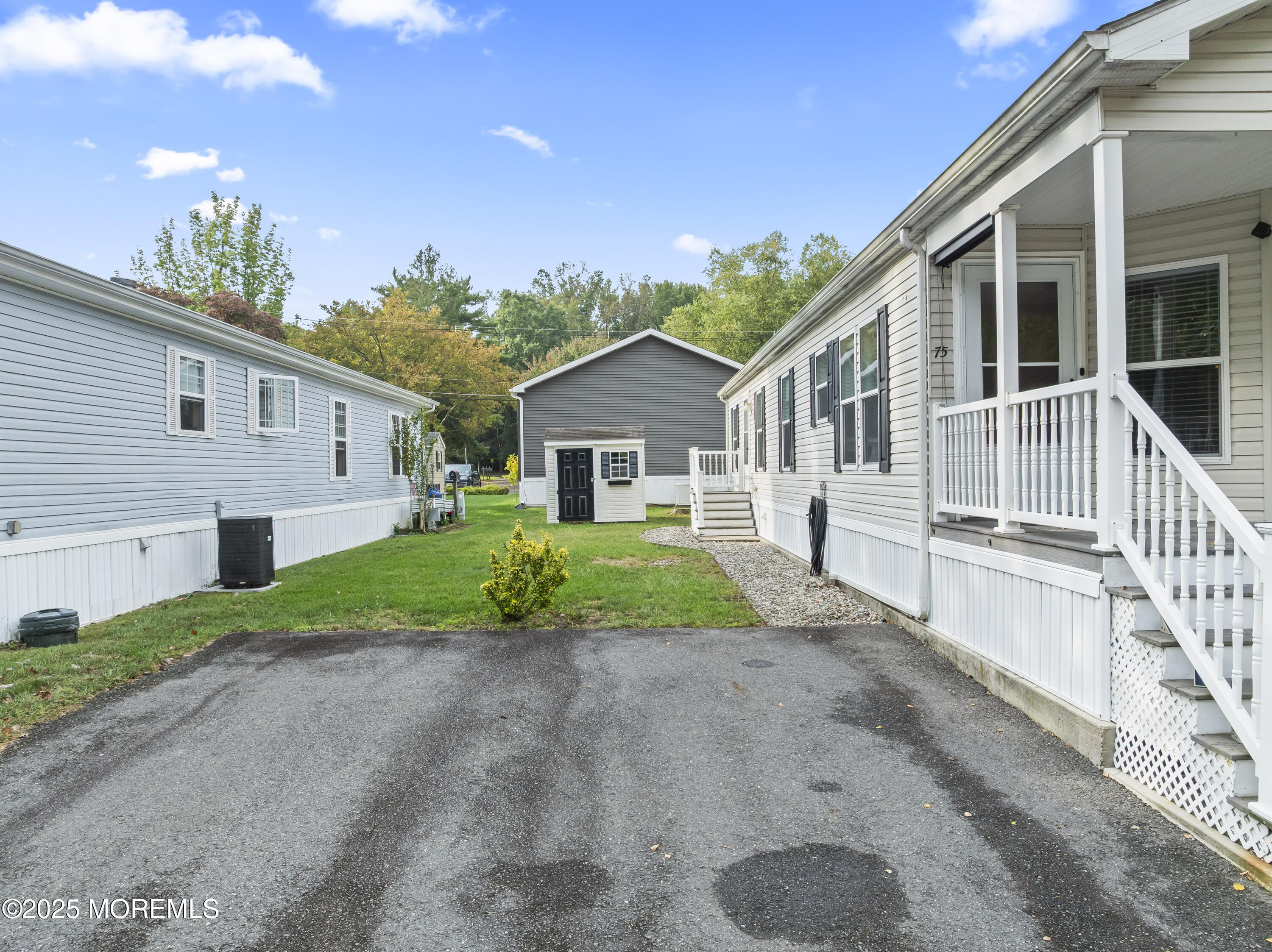 75 Village Road Morganville, NJ 07751 - Photo 23 of 27 a front view of a house with a yard and potted plants
