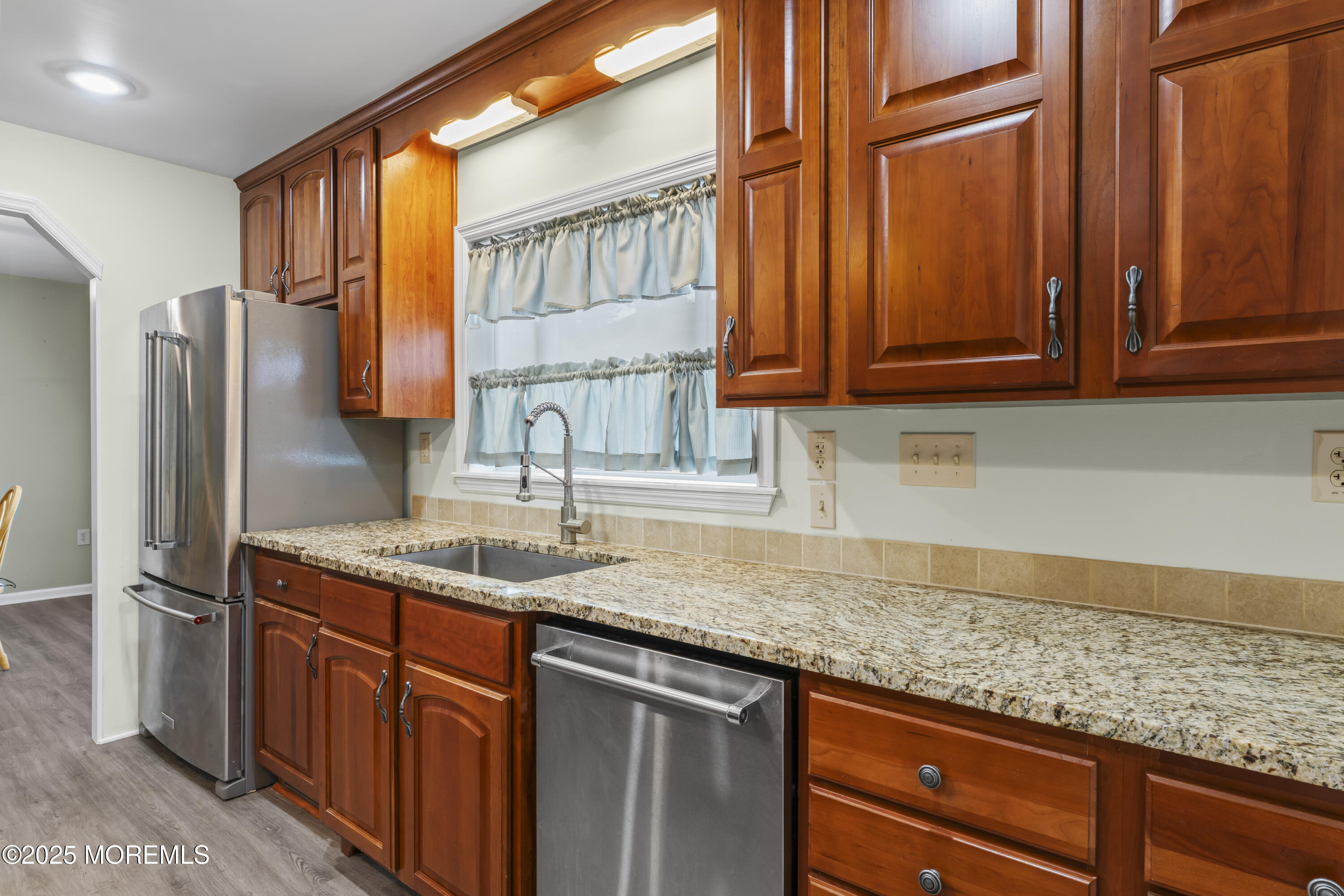 75 Village Road Morganville, NJ 07751 - Photo 8 of 27 a kitchen with stainless steel appliances granite countertop a sink stove and refrigerator