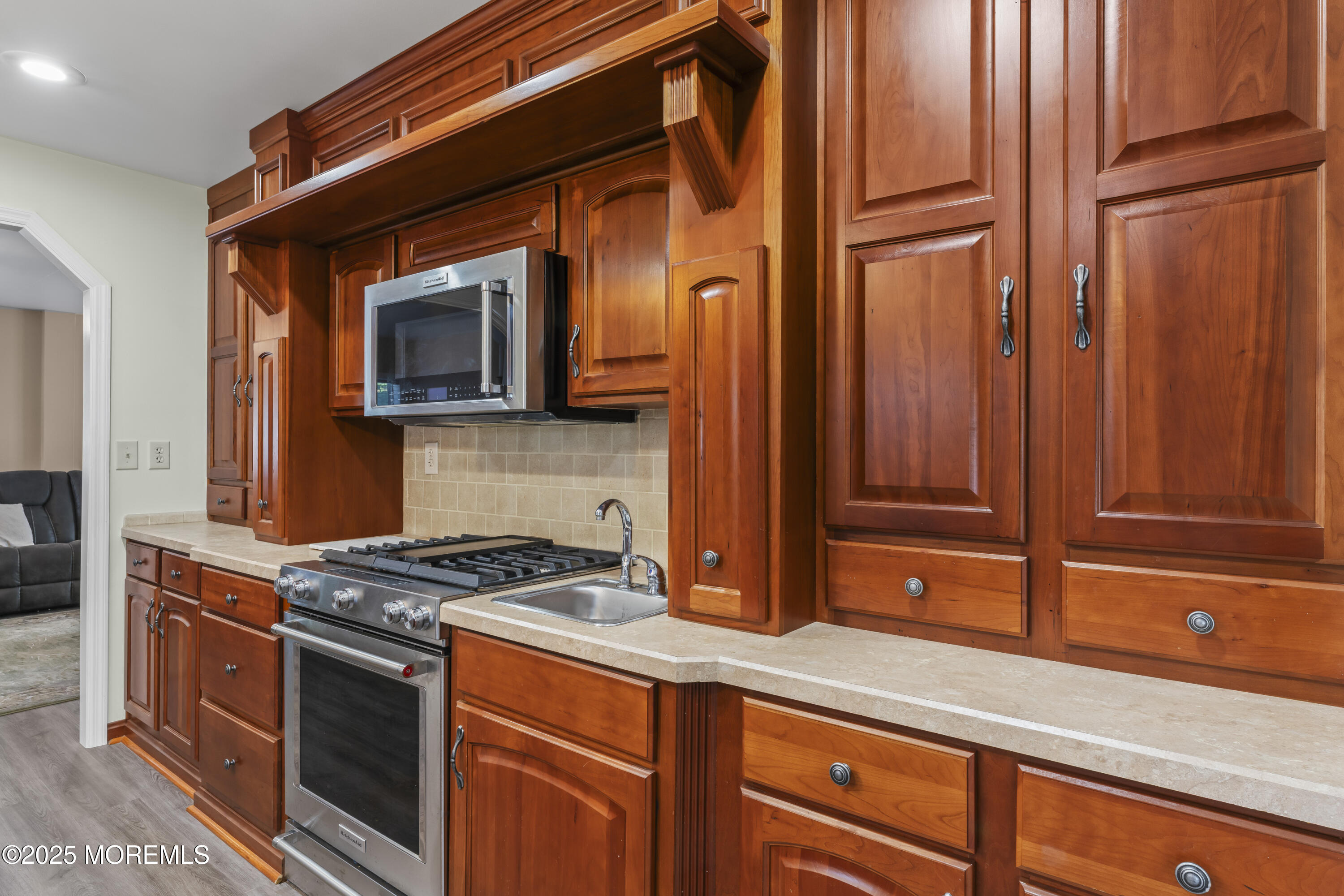 75 Village Road Morganville, NJ 07751 - Photo 9 of 27 a kitchen with stainless steel appliances granite countertop a stove a sink and a microwave