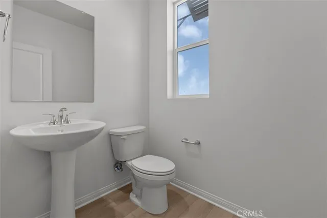 a bathroom with a sink toilet and a mirror