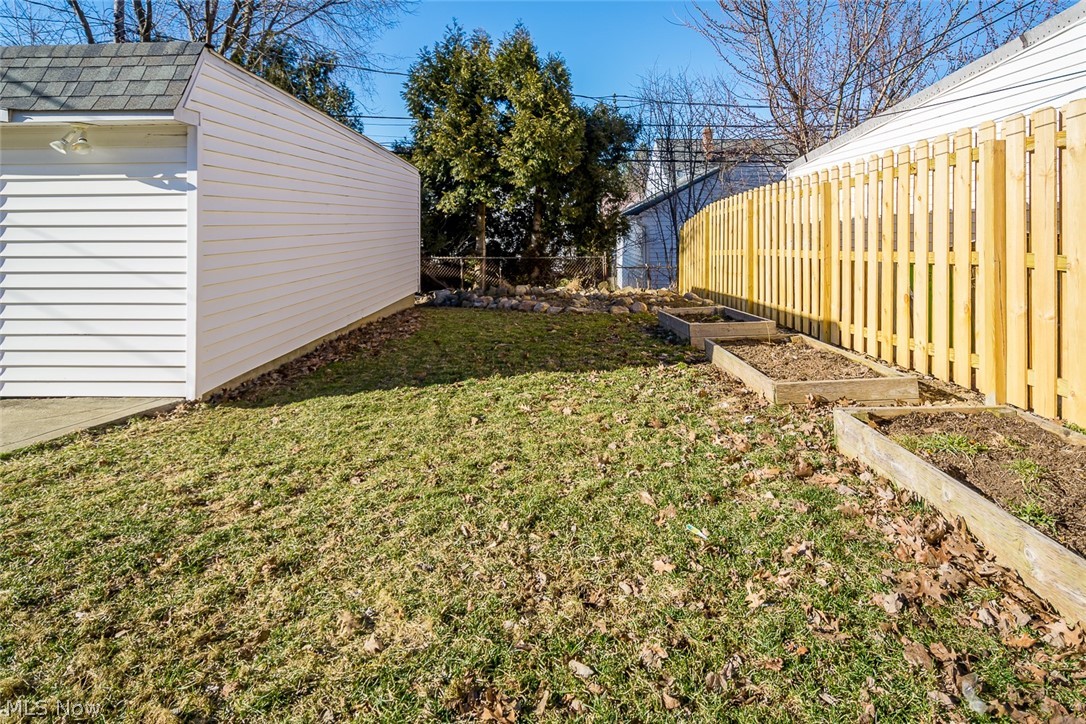 4233 Lambert Road Cleveland, OH 44121 - Photo 24 of 24 View of back kyard with raised bed gardens and privacy fence.