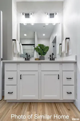 a bathroom with a sink vanity granite and a mirror