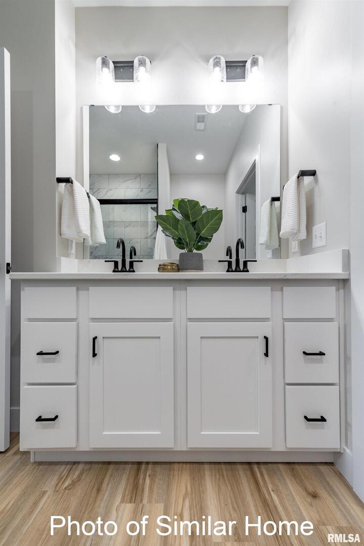 449 North 2nd Street Eldridge, IA 52748 - Photo 15 of 30 a bathroom with a sink vanity granite and a mirror