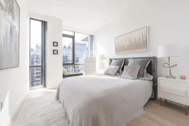 a bedroom with a bed and a window