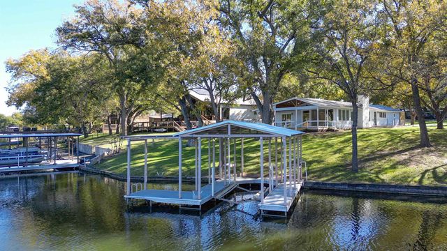 a view of a lake with house in the background