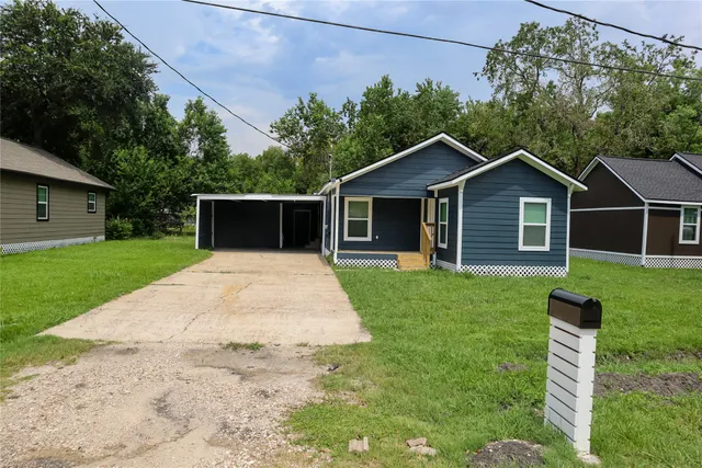 a front view of a house with a garden