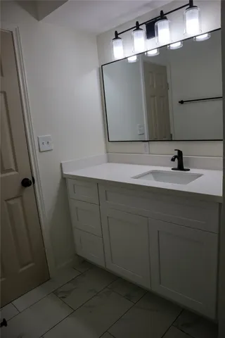 a view of a bathroom from a hallway
