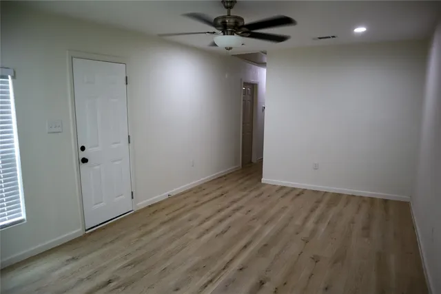a kitchen with granite countertop a refrigerator and a stove top oven