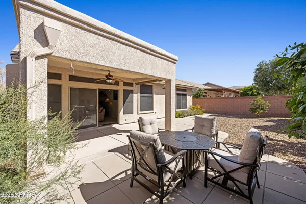 a view of a patio with table and chairs and potted plants
