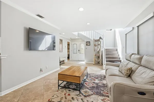 a living room with furniture and a wooden floor