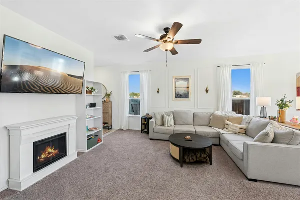 a living room with furniture and a fireplace